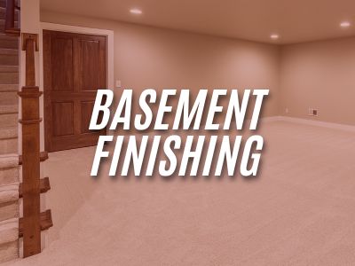 Image with the words "Basement Finishing" overlaying an image of a finished basement with staircase, door, walls, and lighting.