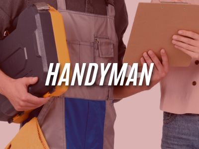 Image with the word "Handyman" overlaying an image of a handyman talking with a woman about the punch list projects she has for him to complete.